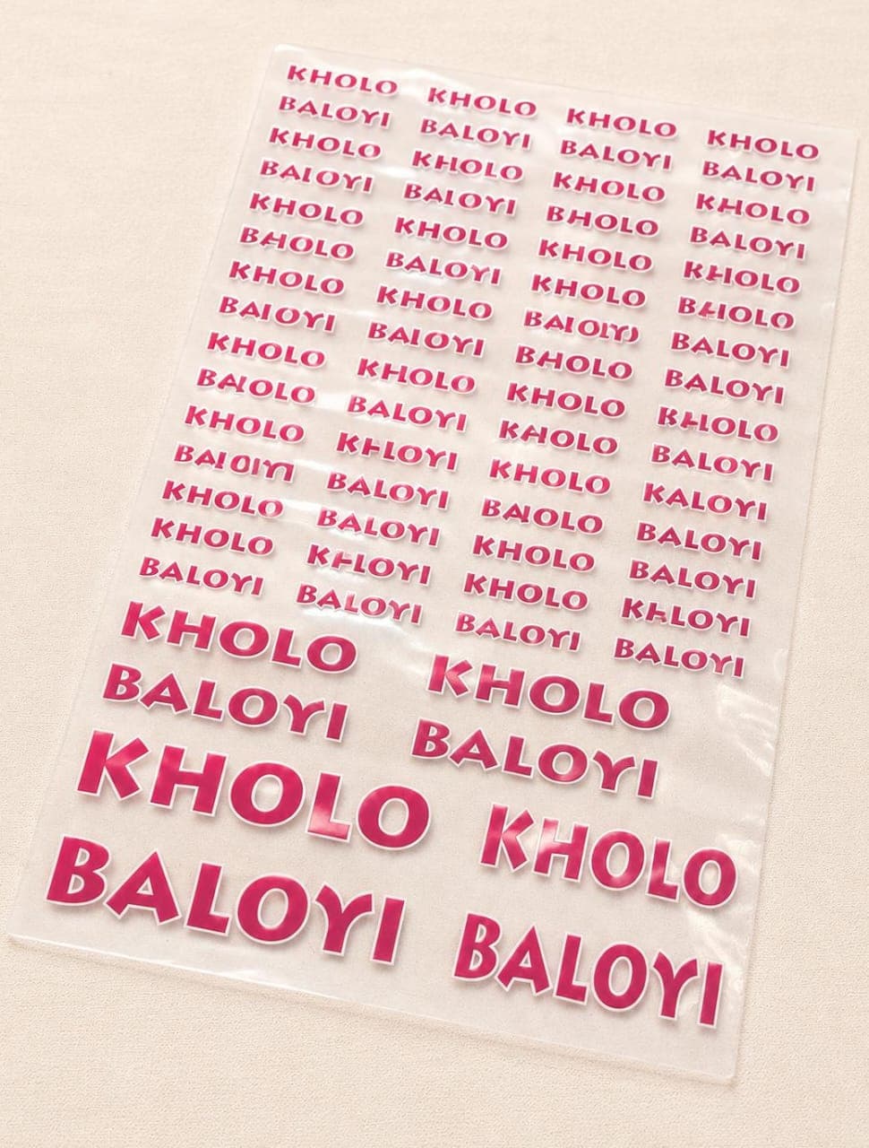 Bold pink personalised name stickers reading Kholo Baloyi