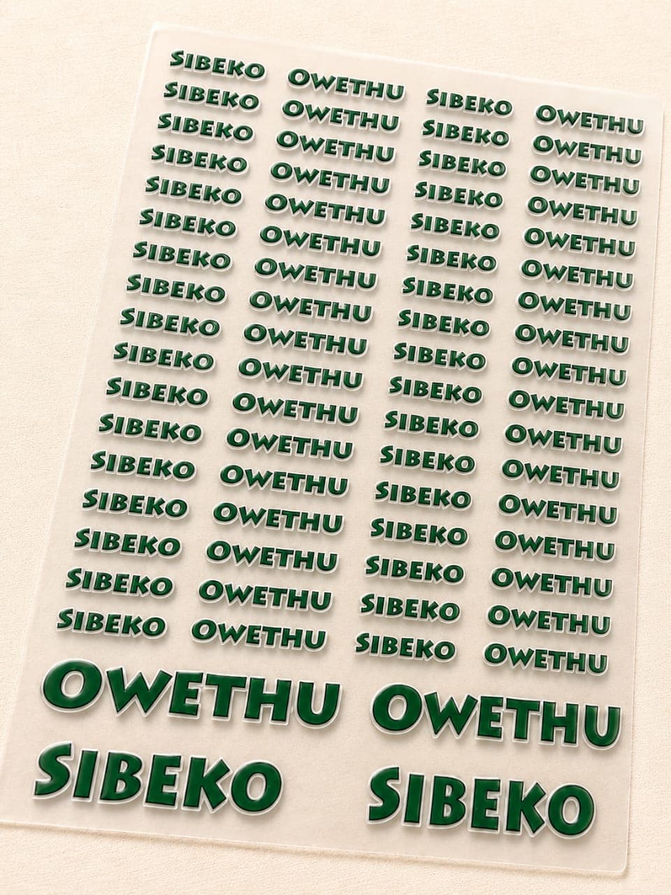 Deep green personalised name stickers reading Sibeko Owethu